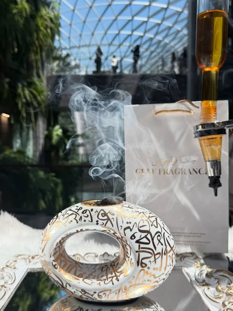 Perfume bottle and Gulf Fragrances bag beside the Jewel waterfall