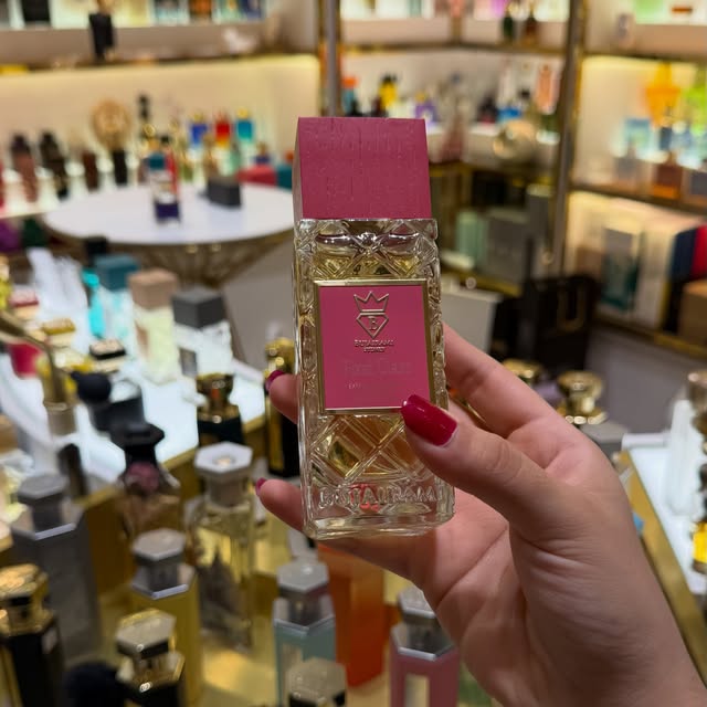 Pink-labelled Bujairami perfume bottle held inside the Gulf Fragrances store
